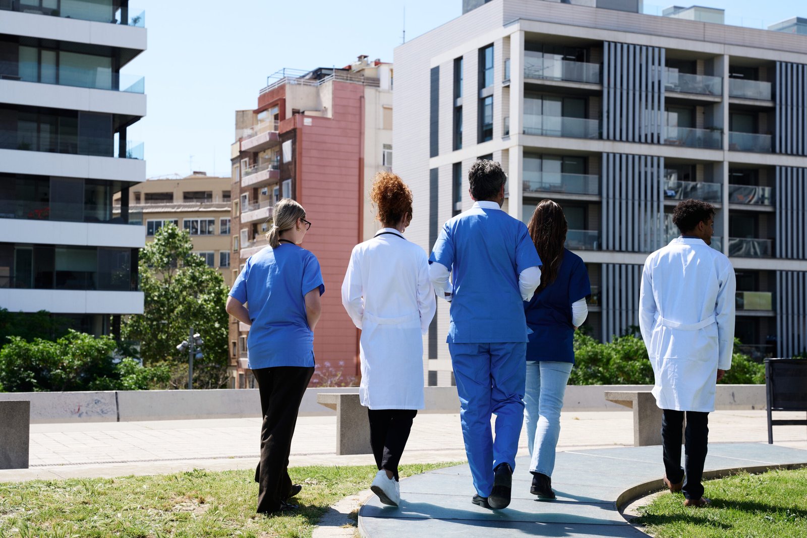 Medical team walking in a city during a break, representing healthcare and public-building elevator projects