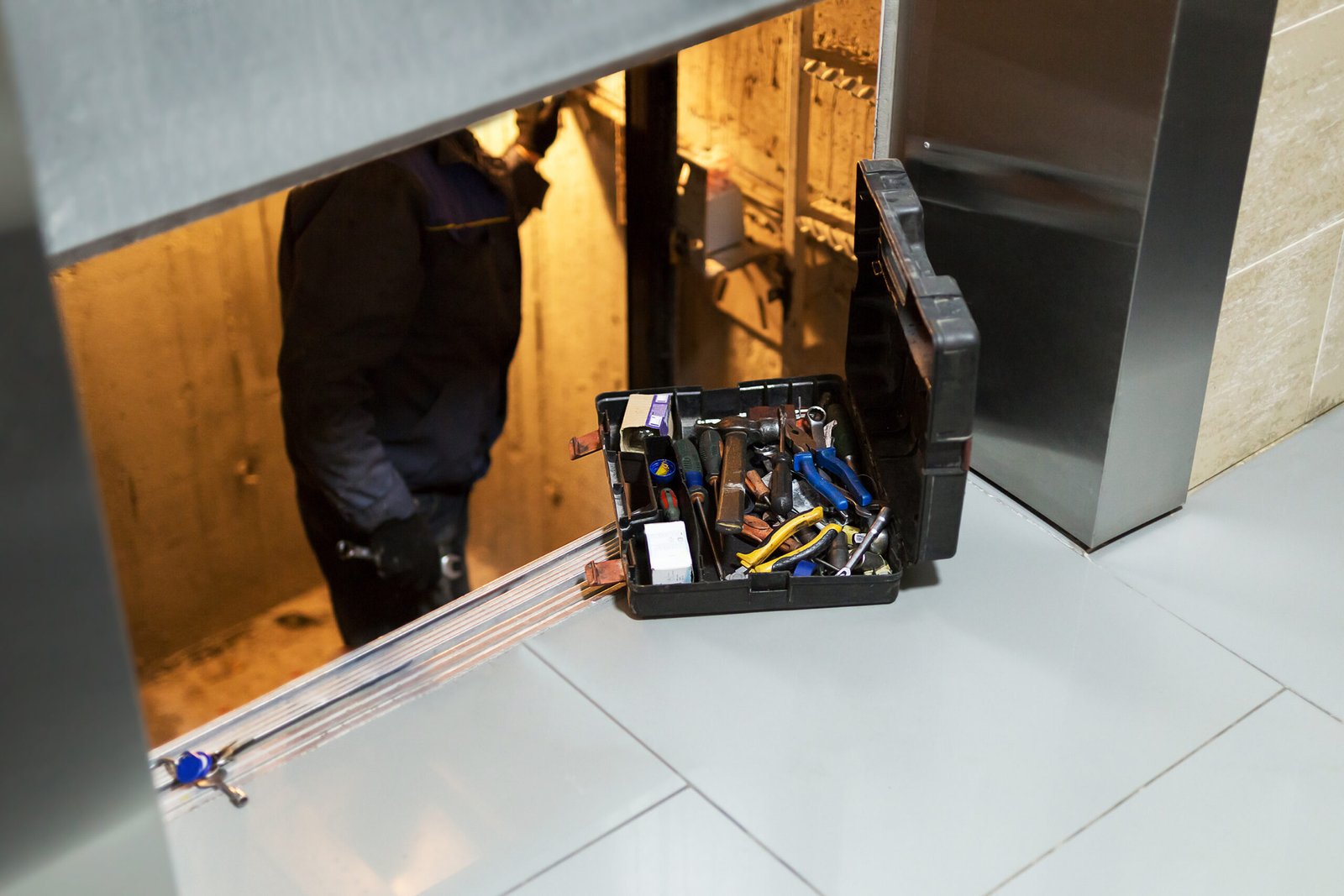 Technician working on elevator equipment during service